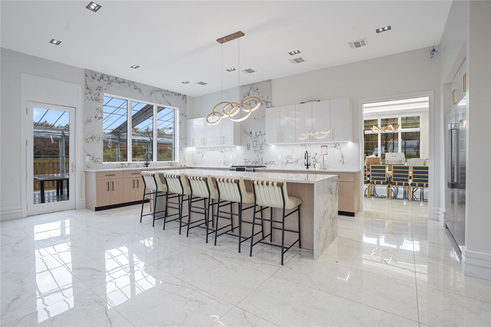 Designer chef’s kitchen with large staging island and breakfast seating